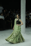 PISTACHIO GREEN EMB LEHENGA SAREE PAIRED WITH A BLACK FLORAL EMB BLOUSE AND EMBELLISHED JACKET.(4 PCS)