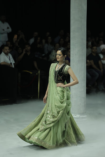 PISTACHIO GREEN EMB LEHENGA SAREE PAIRED WITH A BLACK FLORAL EMB BLOUSE AND EMBELLISHED JACKET.(4 PCS)