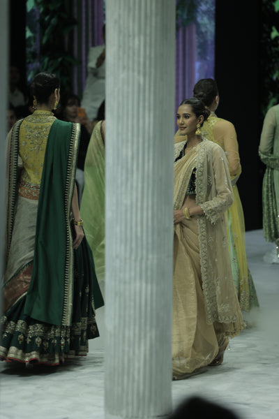 DARK GOLD CRINKLE TISSUE EMBROIDERED SAREE PAIRED WITH A NUDE BUSTIER, GOLD KOTA TISSUE SCALLOP EMBROIDERED JACKET, AND GREEN VELVET EMBROIDERED KOTI. (5 PCS)