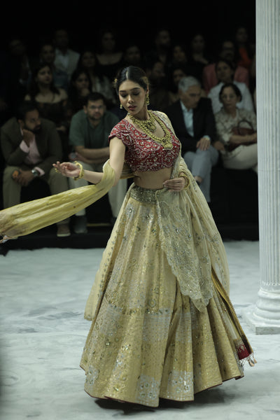 CHAMPAGNE GOLD EMBROIDERED LEHENGA PAIRED WITH A CRIMSON EMBROIDERED BLOUSE AND DUAL EMBELLISHED DUPATTAS. (4 PCS)