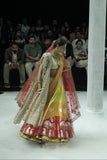 RADHA MULTICOLOUR LEHENGA PAIRED WITH A TOOSH BLOUSE, HEAVY TOOSH EMBROIDERED DUPATTA, ORANGE EMBROIDERED VEIL, AND RED NET EMBROIDERED DUPATTA. (5 PCS)
