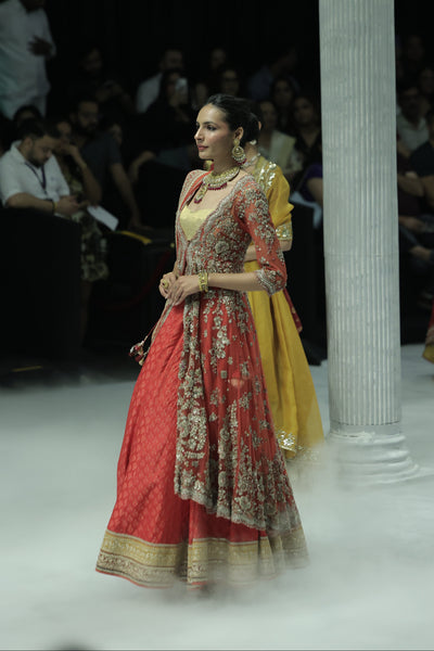 RED TULLE HEAVY EMBROIDERED ANARKALI PAIRED WITH A NUDE BUSTIER, RED BROCADE EMBROIDERED LEHENGA, AND RED TULLE EMBROIDERED DUPATTA. (4 PCS)