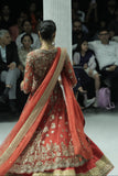 RED TULLE HEAVY EMBROIDERED ANARKALI PAIRED WITH A NUDE BUSTIER, RED BROCADE EMBROIDERED LEHENGA, AND RED TULLE EMBROIDERED DUPATTA. (4 PCS)