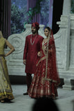 RED BROCADE DOUBLE LAYER LEHENGA PAIRED WITH A RED DUPION EMBROIDERED BLOUSE, RED EMBROIDERED DUPATTA, AND RED EMBROIDERED NET VEIL. (4 PCS)