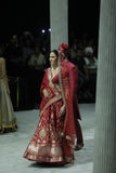 RED BROCADE DOUBLE LAYER LEHENGA PAIRED WITH A RED DUPION EMBROIDERED BLOUSE, RED EMBROIDERED DUPATTA, AND RED EMBROIDERED NET VEIL. (4 PCS)