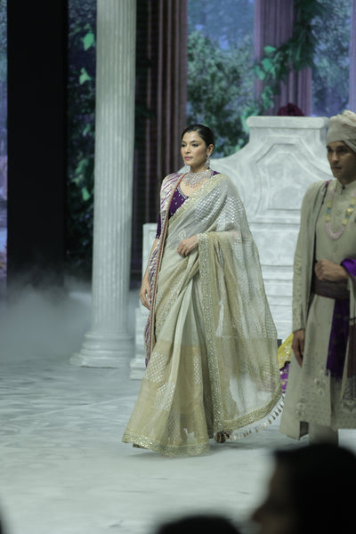 GOLD FOIL-PRINTED TISSUE SAREE PAIRED WITH A PURPLE EMBROIDERED KEDIA AND PEACH TISSUE ANTIQUE BORDER DUPATTA. (3PCS)