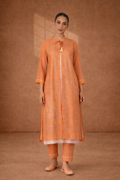 A SOFT ORANGE KOTA SET WITH DELICATE DETAILING FOR EFFORTLESS DAY ELEGANCE
