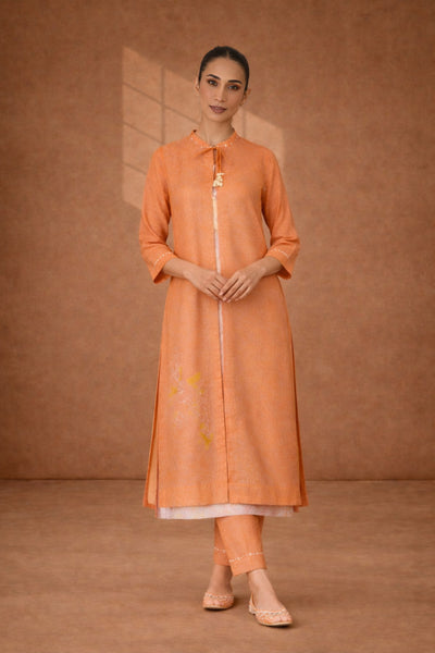 A SOFT ORANGE KOTA SET WITH DELICATE DETAILING FOR EFFORTLESS DAY ELEGANCE