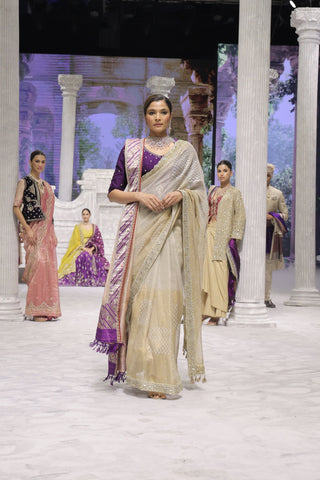 GOLD FOIL-PRINTED TISSUE SAREE PAIRED WITH A PURPLE EMBROIDERED KEDIA AND PEACH TISSUE ANTIQUE BORDER DUPATTA. (3PCS)