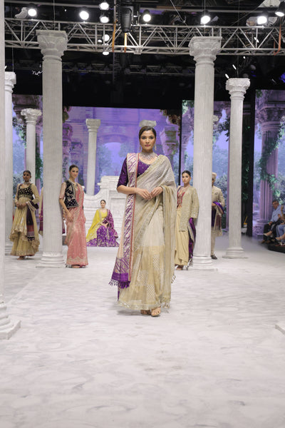 GOLD FOIL-PRINTED TISSUE SAREE PAIRED WITH A PURPLE EMBROIDERED KEDIA AND PEACH TISSUE ANTIQUE BORDER DUPATTA. (3PCS)