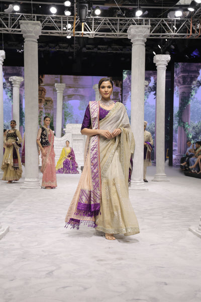 GOLD FOIL-PRINTED TISSUE SAREE PAIRED WITH A PURPLE EMBROIDERED KEDIA AND PEACH TISSUE ANTIQUE BORDER DUPATTA. (3PCS)
