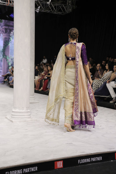 GOLD FOIL-PRINTED TISSUE SAREE PAIRED WITH A PURPLE EMBROIDERED KEDIA AND PEACH TISSUE ANTIQUE BORDER DUPATTA. (3PCS)