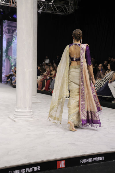 GOLD FOIL-PRINTED TISSUE SAREE PAIRED WITH A PURPLE EMBROIDERED KEDIA AND PEACH TISSUE ANTIQUE BORDER DUPATTA. (3PCS)