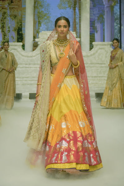 RADHA MULTICOLOUR LEHENGA PAIRED WITH A TOOSH BLOUSE, HEAVY TOOSH EMBROIDERED DUPATTA, ORANGE EMBROIDERED VEIL, AND RED NET EMBROIDERED DUPATTA. (5 PCS)