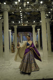 BLUE BROCADE LEHENGA PAIRED WITH A BLUE BUSTIER, PURPLE SILK DUSHALA, AND TOOSH ORGANZA EMBROIDERED DUPATTA.(4PCS)
