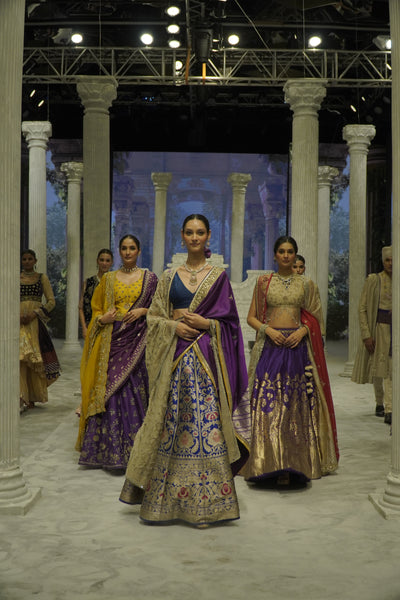 BLUE BROCADE LEHENGA PAIRED WITH A BLUE BUSTIER, PURPLE SILK DUSHALA, AND TOOSH ORGANZA EMBROIDERED DUPATTA.(4PCS)