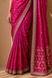 A BRIGHT PINK SAREE WITH SMALL GOLD MOTIFS AND AN EMBROIDERED BORDER. (2PCS)