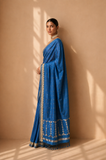 A POWDER BLUE SAREE WITH SMALL MOTIFS AND GOLD BORDER DETAILS. (2PCS)