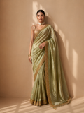 A SOFT PASTEL GREEN SAREE WITH A DETAILED GOLD BORDER. (2PCS)