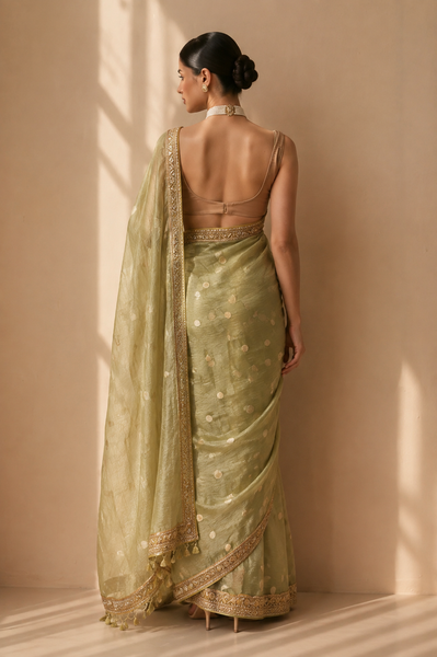 A SOFT PASTEL GREEN SAREE WITH A DETAILED GOLD BORDER. (2PCS)