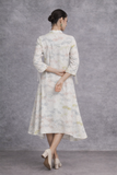 AN IVORY DRESS DEFINED BY FLUID MOVEMENT AND QUIET ELEGANCE