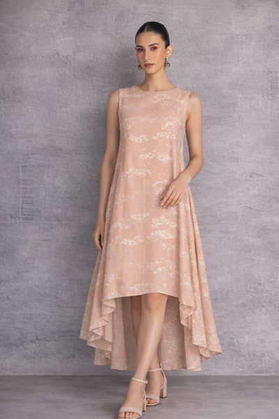 A SOFT PEACH SLEEVELESS DRESS DEFINED BY FLUID MOVEMENTAND SUBTLE GRACE