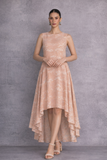 A SOFT PEACH SLEEVELESS DRESS DEFINED BY FLUID MOVEMENTAND SUBTLE GRACE
