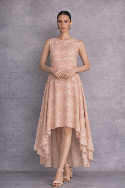 A SOFT PEACH SLEEVELESS DRESS DEFINED BY FLUID MOVEMENTAND SUBTLE GRACE