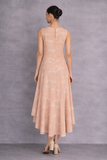 A SOFT PEACH SLEEVELESS DRESS DEFINED BY FLUID MOVEMENTAND SUBTLE GRACE