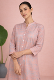 A PEACH TUNIC SHAPED IN FLUID EASE AND UNDERSTATED REFINEMENT