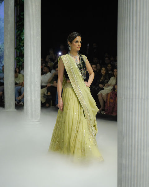PISTACHIO GREEN EMB LEHENGA SAREE PAIRED WITH A BLACK FLORAL EMB BLOUSE AND EMBELLISHED JACKET.(4 PCS)