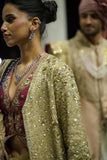 GOLD DRAPE SKIRT PAIRED WITH A RUBY EMBROIDERED KOTI, GOLD TISSUE EMBROIDERED LONG JACKET, AND PURPLE ANTIQUE DUPATTA. (4 PCS)