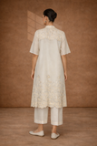 A SOFT IVORY TUNIC WITH DELICATE FLORAL DETAILING FOR EFFORTLESS ELEGANCE