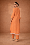 A SOFT ORANGE KOTA SET WITH DELICATE DETAILING FOR EFFORTLESS DAY ELEGANCE