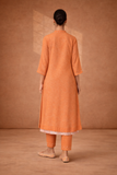 A SOFT ORANGE KOTA SET WITH DELICATE DETAILING FOR EFFORTLESS DAY ELEGANCE