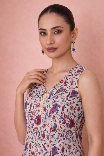AN IVORY TUNIC DEFINED BY DELICATE PATTERNING AND EFFORTLESS EASE