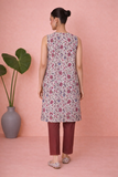 AN IVORY TUNIC DEFINED BY DELICATE PATTERNING AND EFFORTLESS EASE