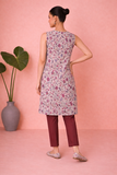 AN IVORY TUNIC DEFINED BY DELICATE PATTERNING AND EFFORTLESS EASE