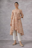 A SOFT PEACH PRINTED TUNIC WITH A FLUID , FLARED SILHOUETTE AND UNDERSTATED ELEGANCE