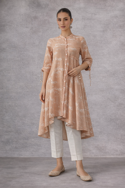 A SOFT PEACH PRINTED TUNIC WITH A FLUID , FLARED SILHOUETTE AND UNDERSTATED ELEGANCE