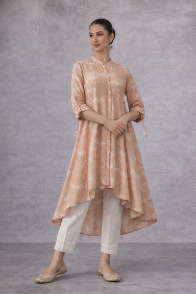A SOFT PEACH PRINTED TUNIC WITH A FLUID , FLARED SILHOUETTE AND UNDERSTATED ELEGANCE