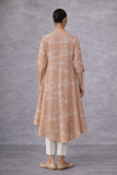A SOFT PEACH PRINTED TUNIC WITH A FLUID , FLARED SILHOUETTE AND UNDERSTATED ELEGANCE