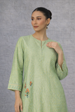 A SOFT GREEN KURTI DEFINED BY GENTLE DETAILING AND FLUID EASE