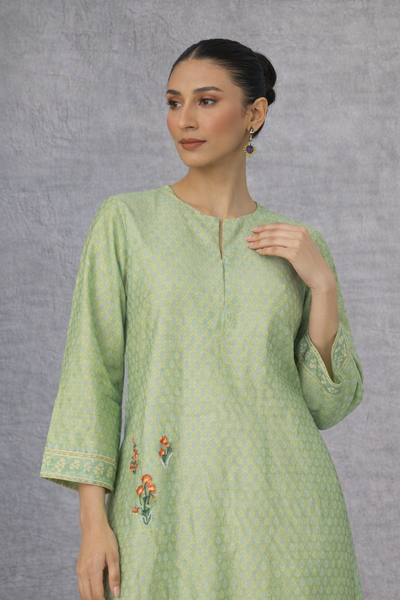 A SOFT GREEN KURTI DEFINED BY GENTLE DETAILING AND FLUID EASE