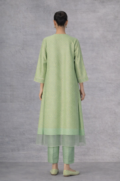 A SOFT GREEN KURTI DEFINED BY GENTLE DETAILING AND FLUID EASE