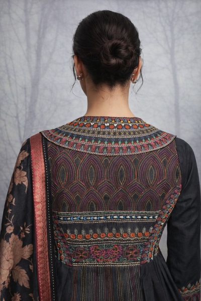 A BLACK EMBROIDERED DUPION SILK JACKET PAIRED WITH A PRINTED TUSSAR SILK SAREE