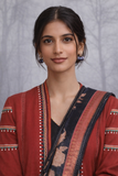 A MADDER RED LINEN JACKET PAIRED WITH A BLACK TUSSAR SILK SAREE.