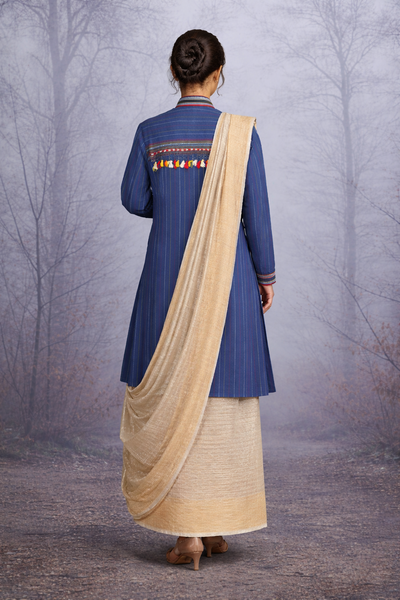 A BLUE COTTON HANDLOOM JACKET PAIRED WITH A BEIGE TUSSAR SILK SAREE.