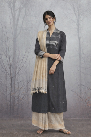 A BLACK HANDLOOM COTTON JACKET WITH MINIMAL WOVEN DETAILS.