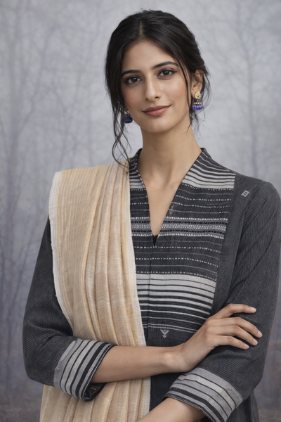 A BLACK HANDLOOM COTTON JACKET WITH MINIMAL WOVEN DETAILS.